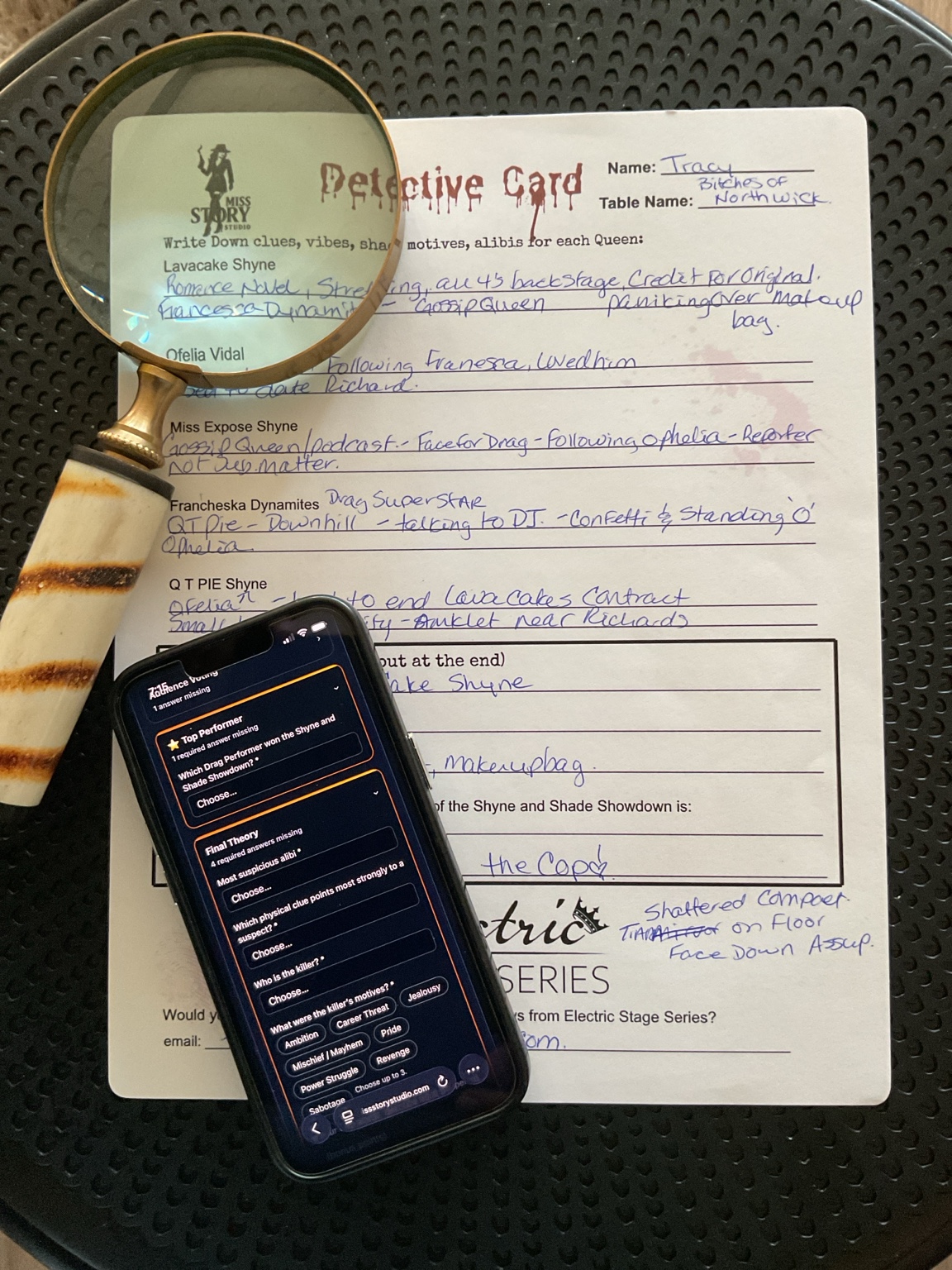 A completed Miss Story Studio Detective Card beside the custom Detective App